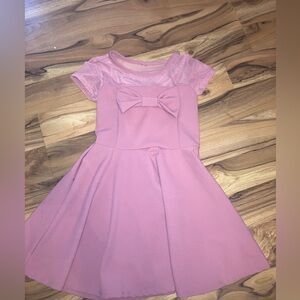 Beautiful pink kids dress with bow.